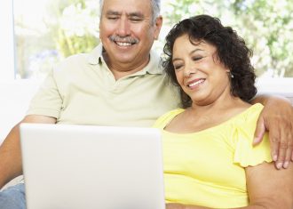 Senior Couple Using Laptop to set up retirement plan